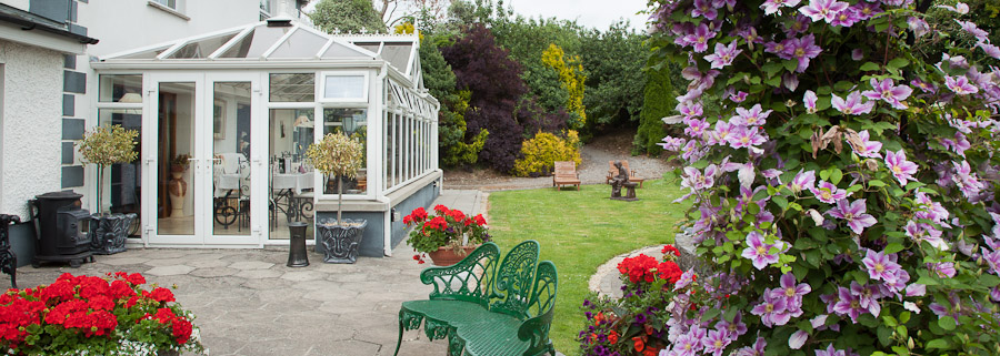 Glasha Farmhouse conservatory and flowering garden