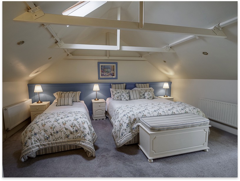 Twin bedroom with exposed ceiling beams