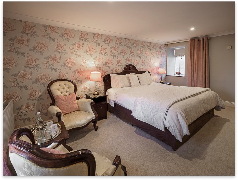 Double bedroom with floral wall covering